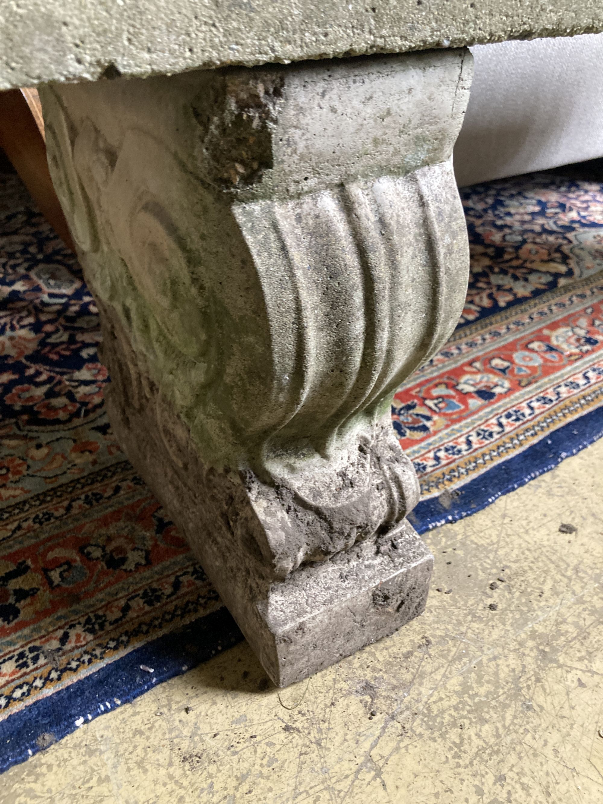 A reconstituted stone garden bench seat, length 126cm, depth 38cm, height 45cm